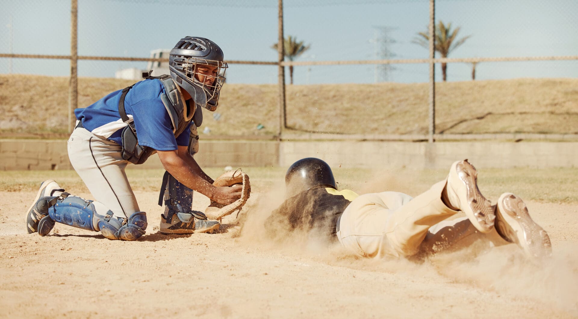 A baseball player sliding into home base