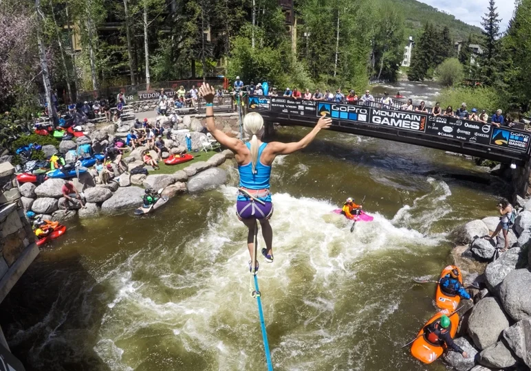 A person on a board is jumping over the water