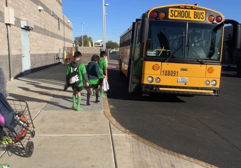 A school bus is driving down the street.