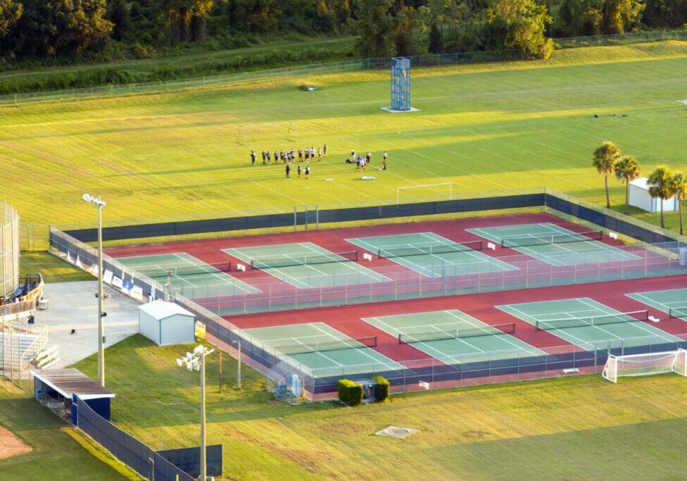 New tennis court stadiums on public school yard in rural Florida. Open air ballpark American sport infrastructure.